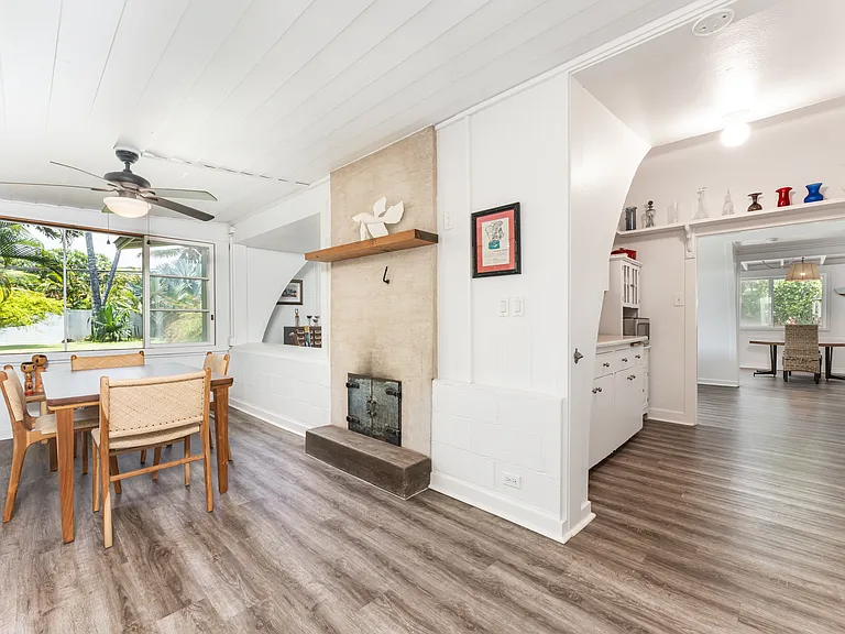 Open dining area with updated flooring, abundant natural light, and charming architectural details that create a warm and inviting gathering space.