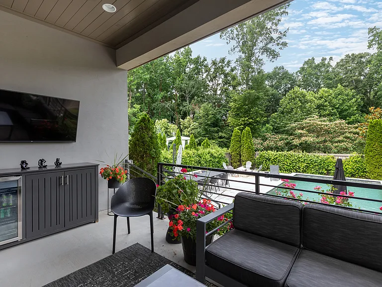 Patio area provides shade and is a great area to relax while taking in your favorite show or sporting event. Refrigerator and towel storage on hand.