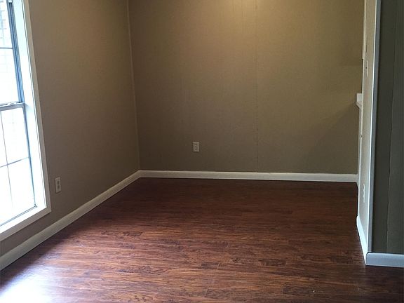 Dining area and partial living room view.