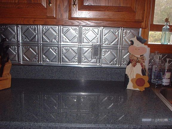 Granite counter tops with tin backsplash