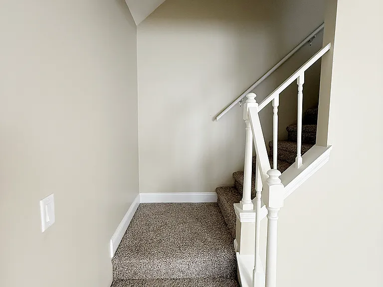 STAIRWAY TO UPSTAIRS BEDROOMS, UPSTAIRS HALL BATH, LAUNDRY AREA.