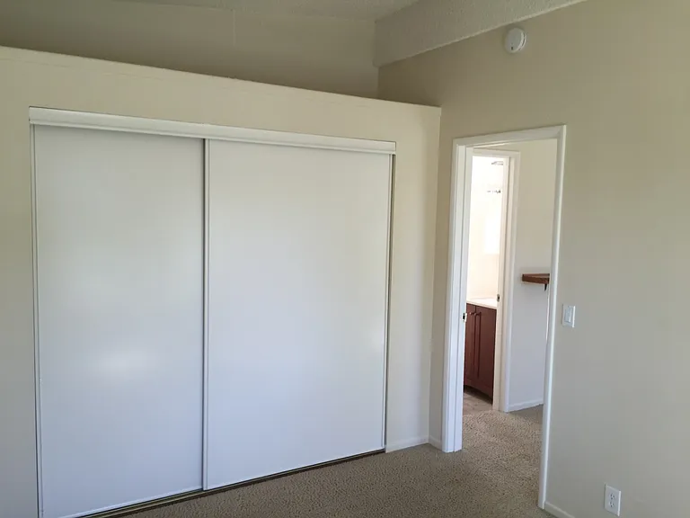 Bedroom with 9-foot wide closet and storage above.
*Carpet has been replaced with wood plank flooring.