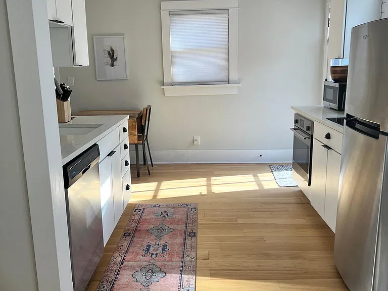 Kitchen area includes full size dishwasher, sink, microwave, Keurig coffee maker, toaster, cooktop, oven, refrigerator, & air fryer.