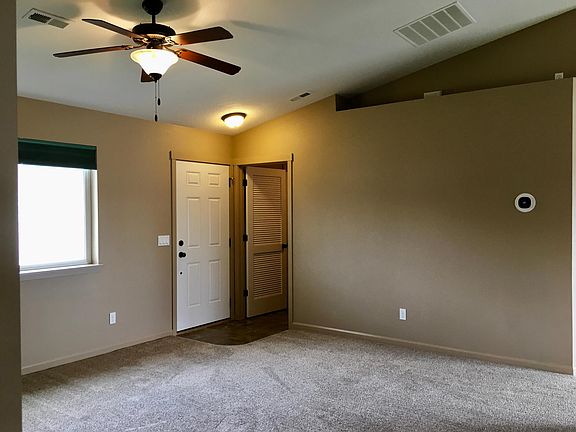 Living room looking towards front door and laundry room door.