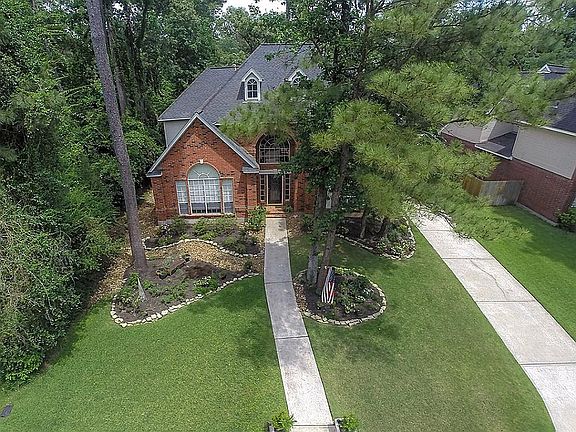 This PRIVATE David Weekley home is surrounded by lots of trees and lush landscaping.
