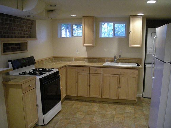 Kitchen with gas range, stacked w/d. Equipped with microwave, toaster oven, kitchen basics.