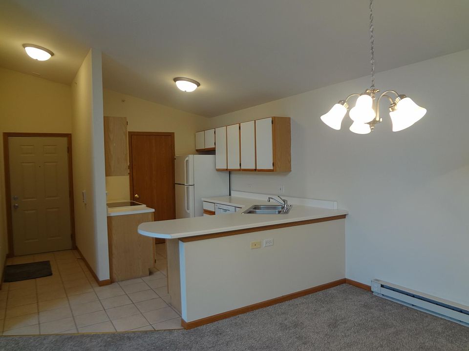 Kitchen features newer appliances, ample storage, breakfast bar& laundry closet.