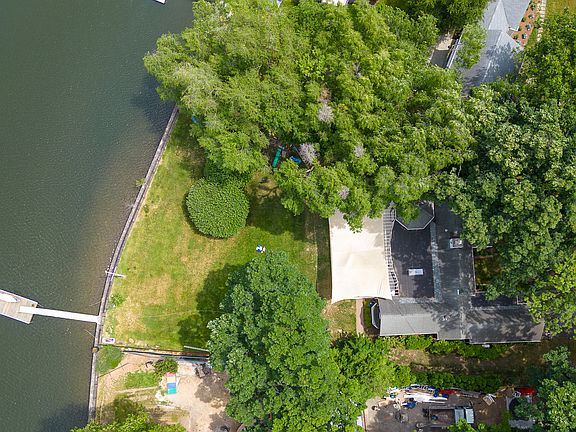 Aerial View of waterfront property featuring a private dock with boat slip.