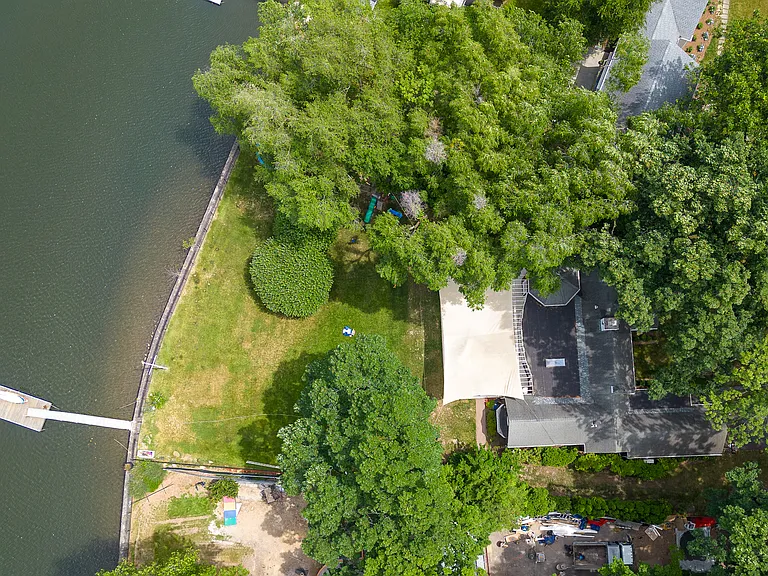 Aerial View of waterfront property featuring a private dock with boat slip.