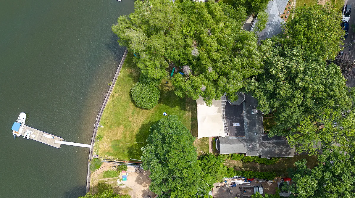 Aerial View of waterfront property featuring a private dock with boat slip. - 658 Shore Acres Dr