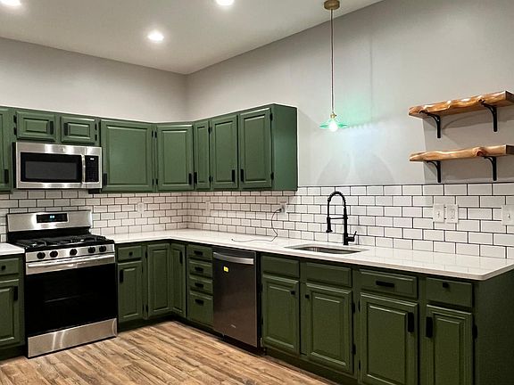 Open Shelving and stainless steel Appliances in the Kitchen