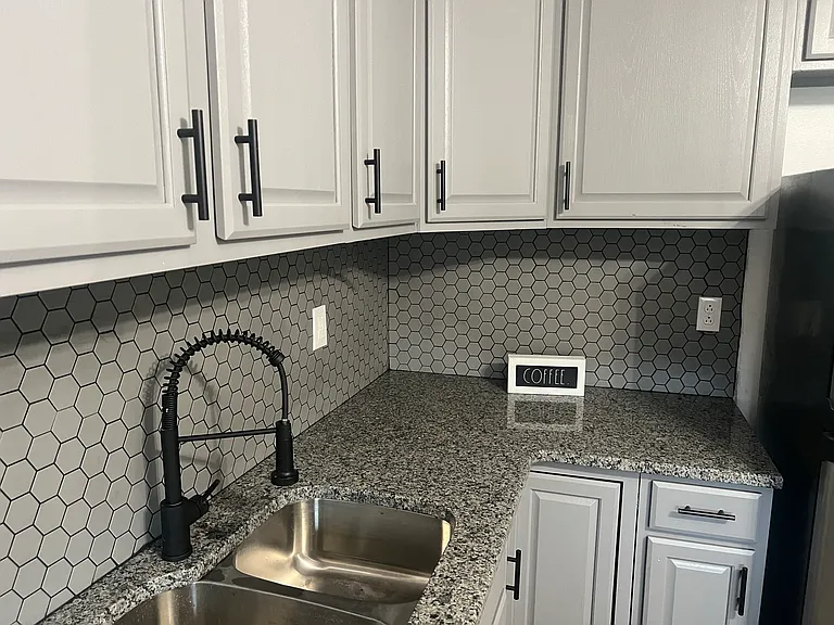 Granite and updated fixtures for a well-appointed kitchen.