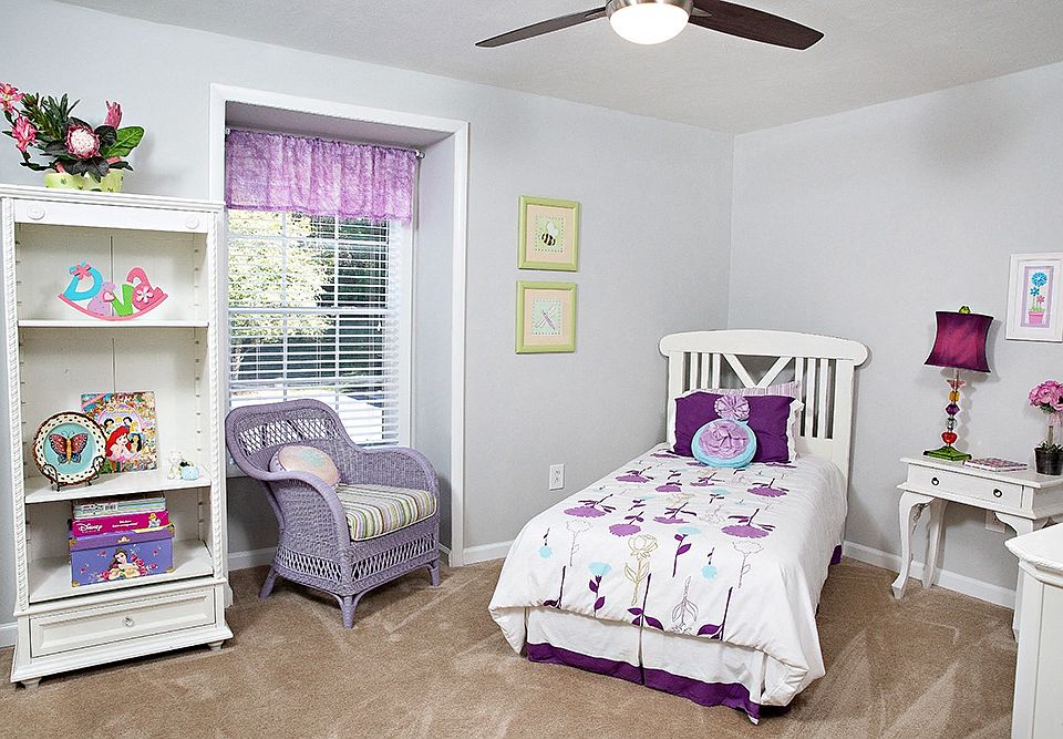 a bedroom with a bed, a dresser, and a window