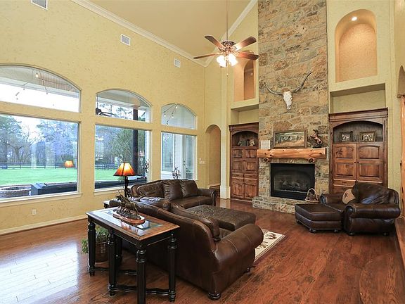 Large family room with 2 story fireplace and wall of windows overlooking backyard! NO immediate neighbors! Adjoining properties are 20+ acres each!