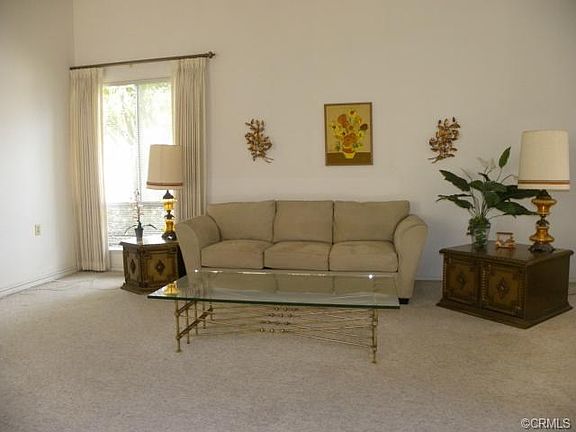 spacious living room with lots of natural light and an A/C unit.