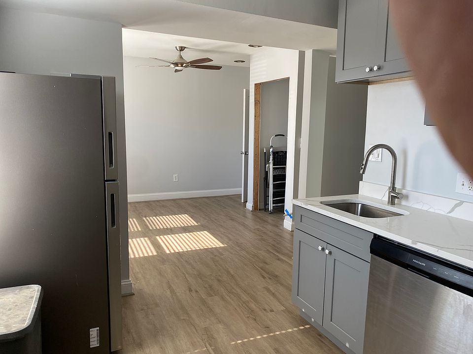 kitchen and living/dining room with view of washer/dryer closet (custom doors on order)