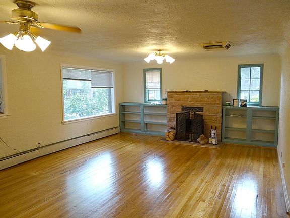Greenroom with wood floors and fireplace