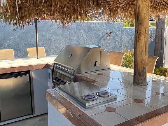 Built in BBQ area with small fridge and room for 6-8 barstools!