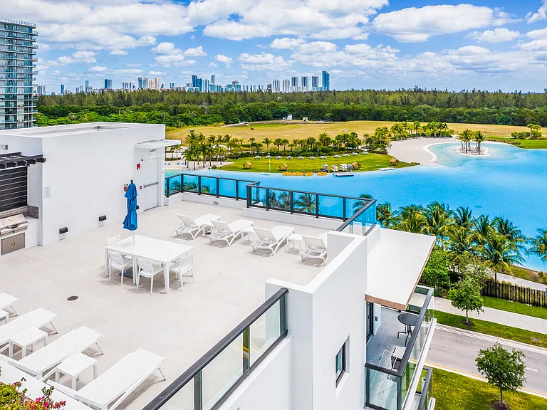 Elevated rooftop sundeck with sweeping lagoon and skyline views. tour today and find your perfect home!