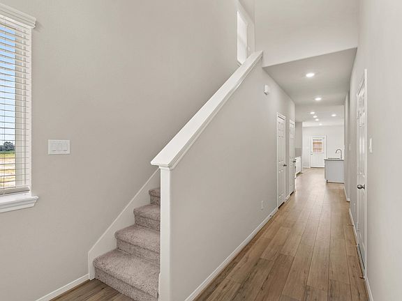The entryway features a staircase, closet and peek into your open concept living space.