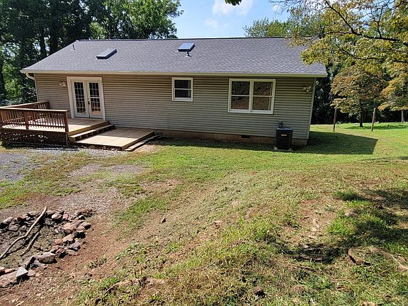 Rear of home, with new back deck and roof/gutters/etc