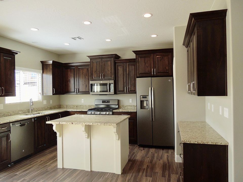 Excellent kitchen layout with granite counters, stainless appliances, built-in desk, and large pantry.