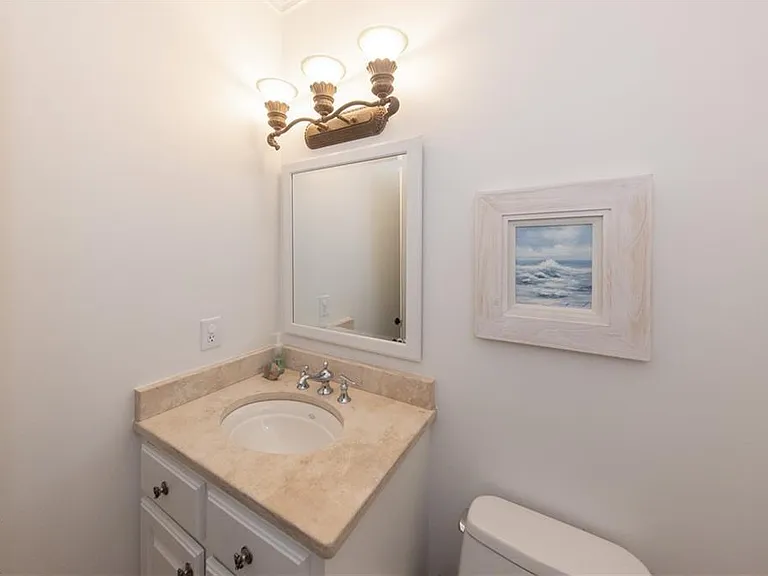 Downstairs half bathroom off of the living room and kitchen.