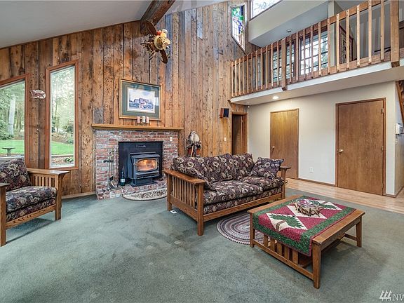 Living room has wood-burning stove insert and brick hearth