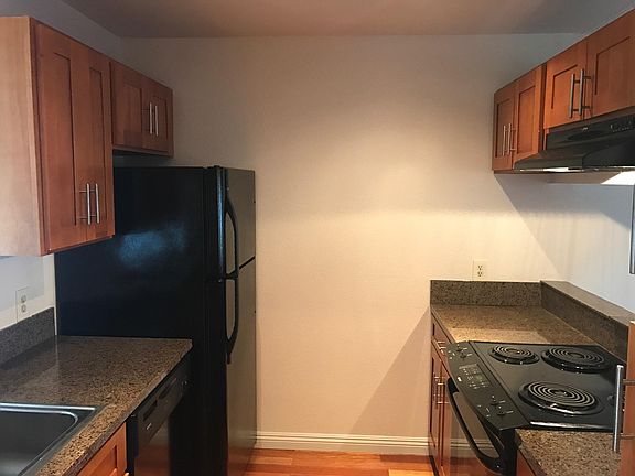 After you walk through the front door to the left you'll find the Kitchen. All black appliances and granite counter tops.