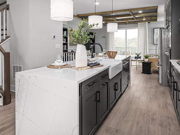 Open main level with island kitchen in a DRB Homes Rockland model at the Locke Landing community.