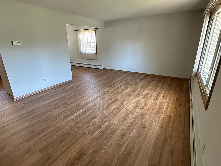 Open living room with huge windows letting in plenty of natural light.