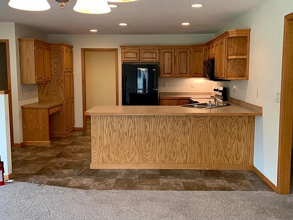 Kitchen view from Dining Room. Laundry Room with 1/2 bath and large storage closet through the pocket door next to fridge.