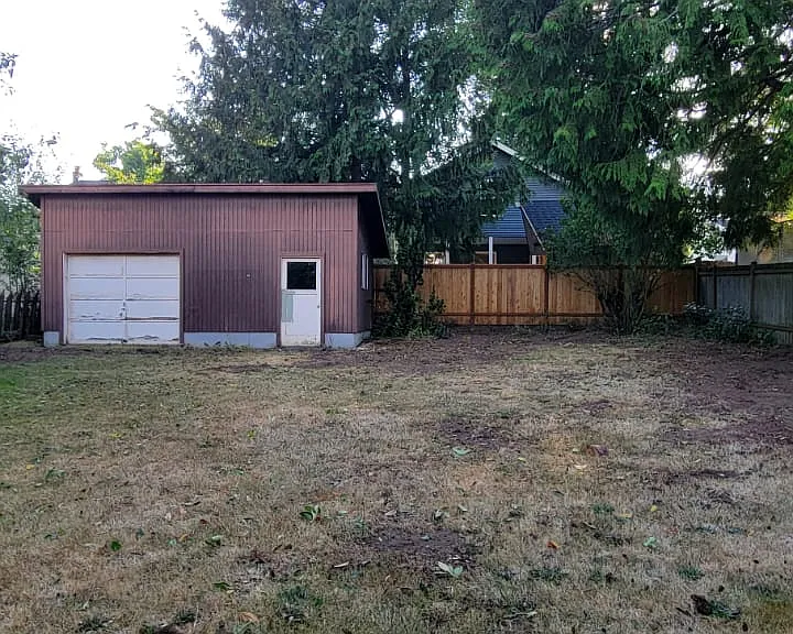 backyard.
Old garage can now be used for additional storage.