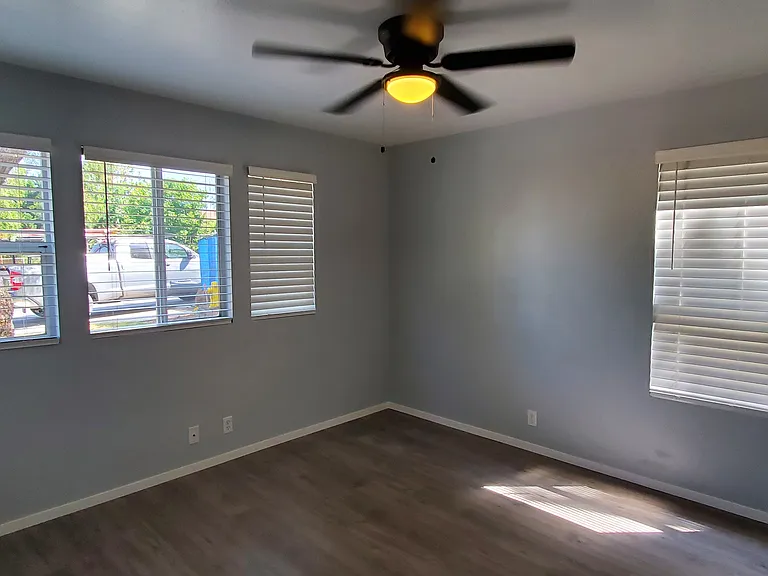 Bedroom2 has 4 windows with blinds and ceiling fan