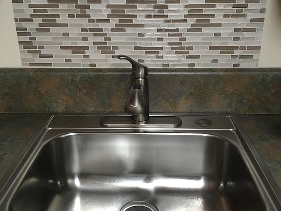 Single bowl stainless sink with pull down faucet and disposal