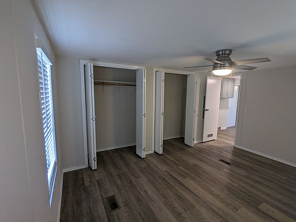 master bedroom with double closet, windows on two sides