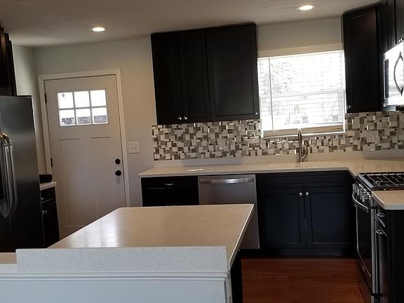 tons of cabinetry and beautiful backsplash
