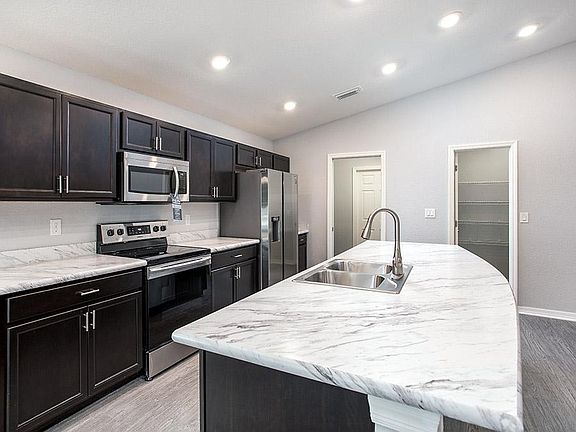 Enjoy your spacious kitchen with luxurious finishes and lots of storage - Photo showcases a home wit