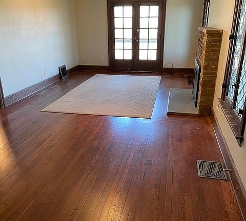 Spacious living room with french door outside access and fireplace