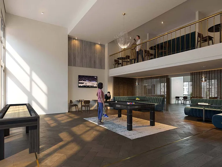 Two-story clubroom featuring a catering kitchen, game room and a TV room with oversized soft seating.