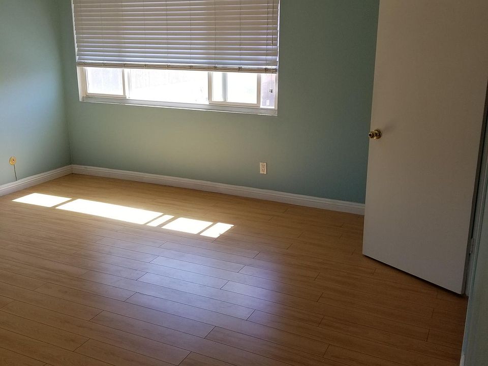 Master's bedroom with large double-panel window and blinds.