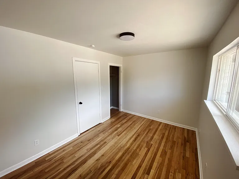 First bedroom with closet and natural light.