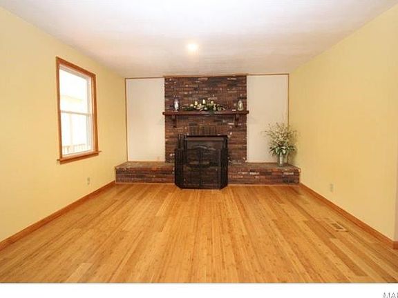 Living Room with wood burning fireplace and bamboo flooring throughout.
