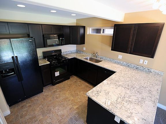 Dark cabinets with slab granite counter tops