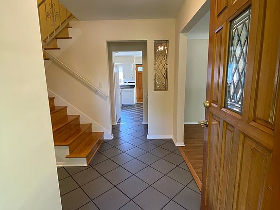 Entryway (kitchen is straight ahead; powder room is to the left; living room and dining room are to the right; and stairs up to the 2nd floor where there are three bedrooms and two bathrooms).