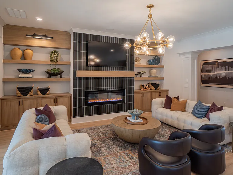 Clubhouse living room with ample seating, fireplace and TV.