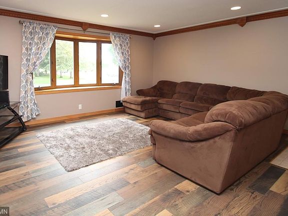 Main floor living room with a bay window and newer flooring.