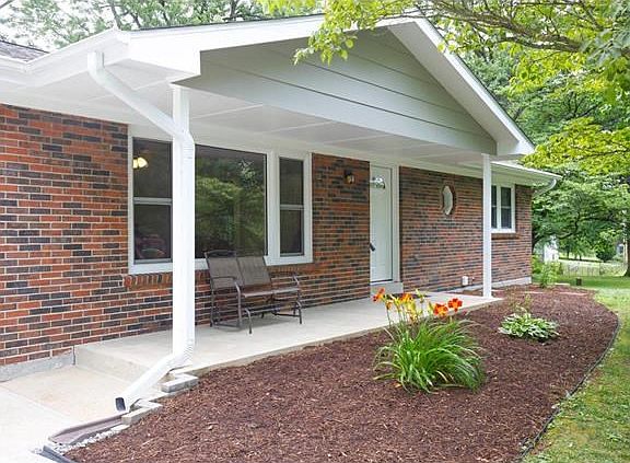 Covered front porch, new pillars, soffits, fascia, windows, landscaping and door