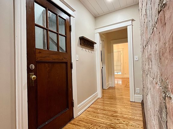 Front door opens to exposed brick