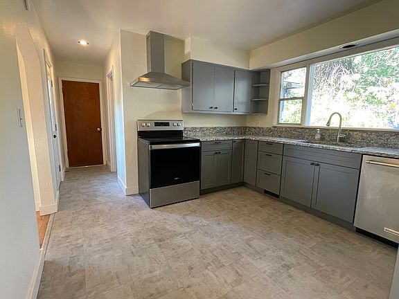 Remodeled kitchen with new flooring, countertops and appliances.